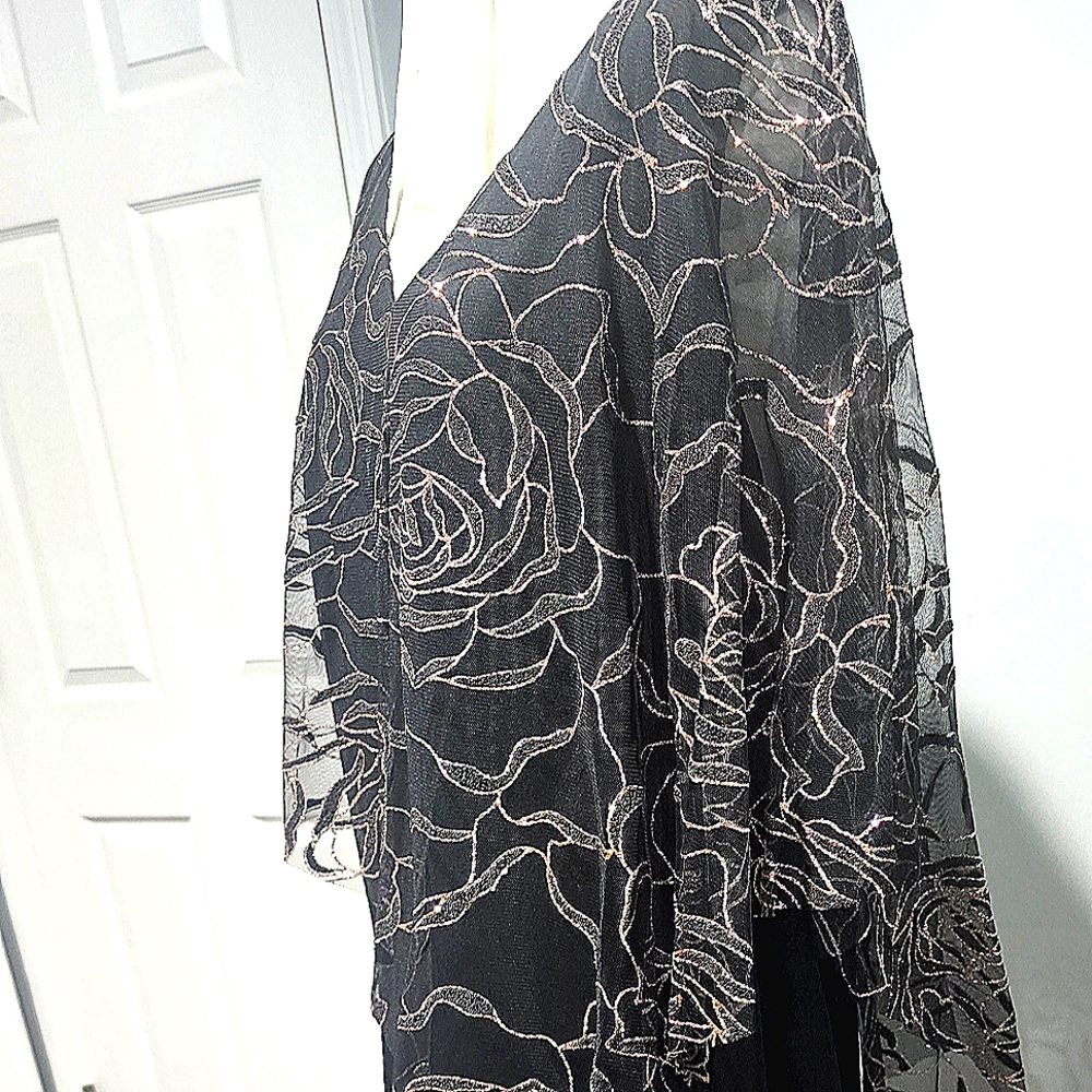 Black gown with gold accents to it. The overlay attached has a split in the back